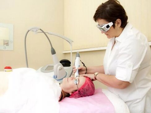 Cosmetologist performs laser rejuvenation procedure